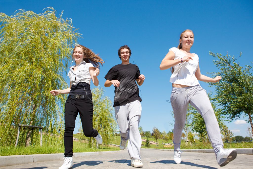 Highschool students running in park