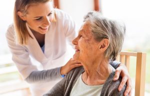 Health visitor and a senior woman during home visit.