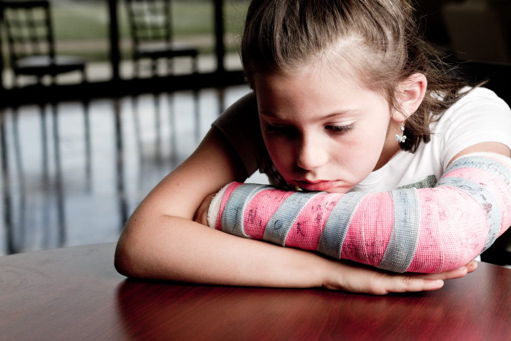 Young girl with cast on her broken arm