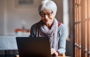 Shot of a senior woman using a laptop in a retirement home