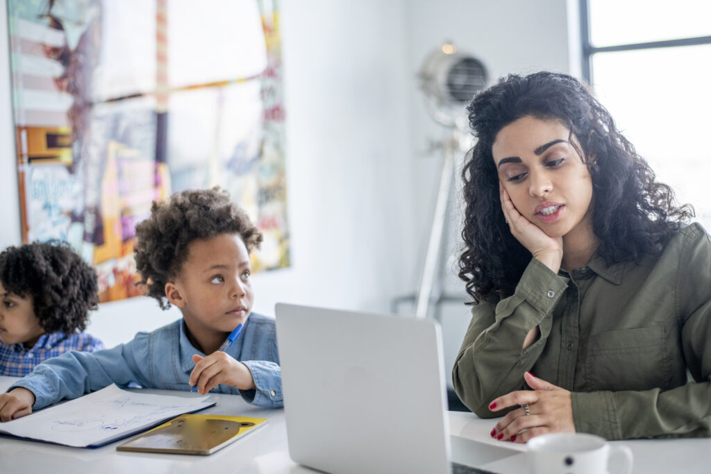 Young mother working from home during lockdown with her child.