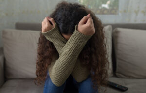 Unhappy girl on sofa