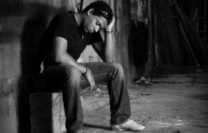 a man sitting alone in a dark place