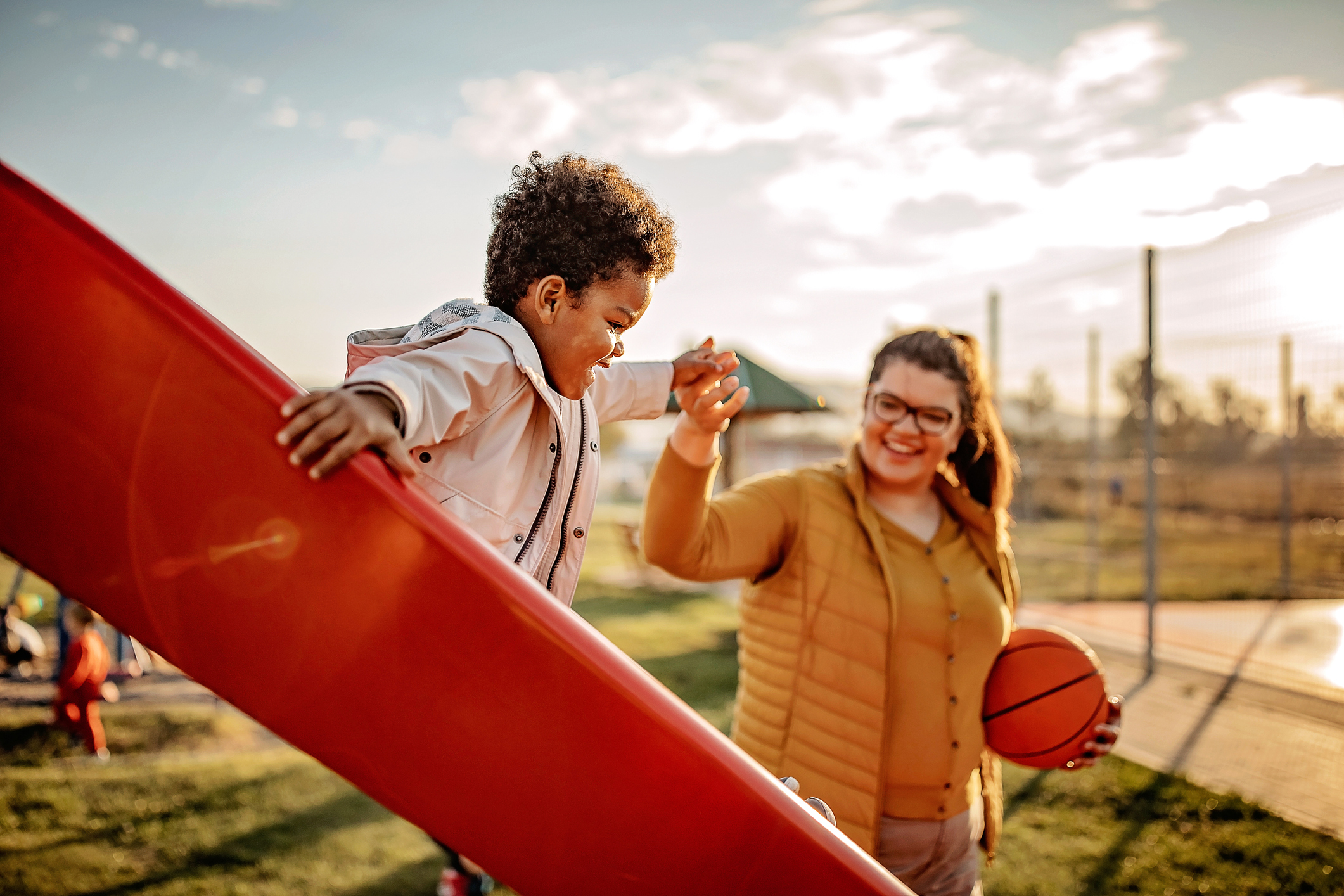 Kid playing with mother in public park