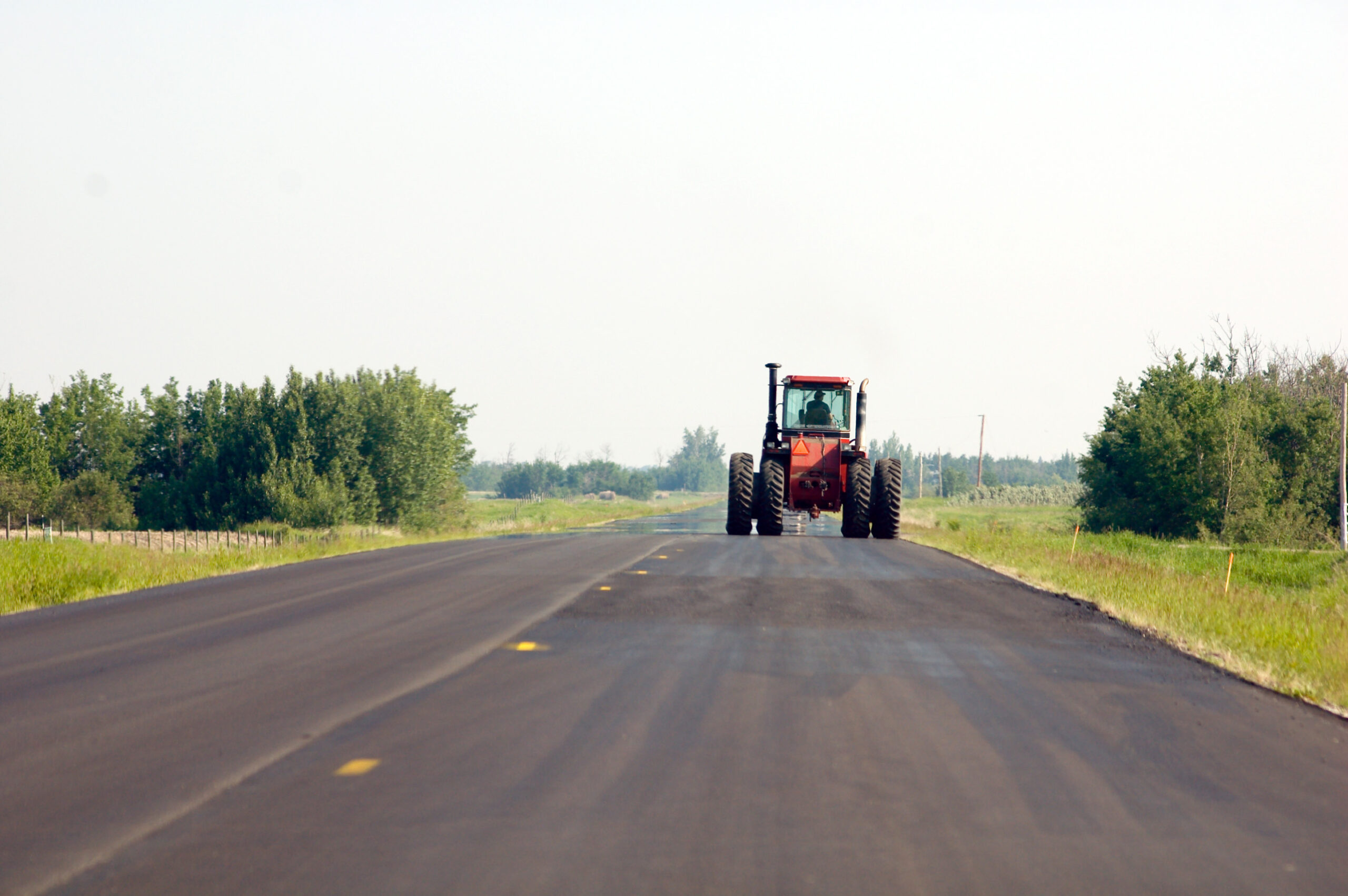 A large tractor going down a country road