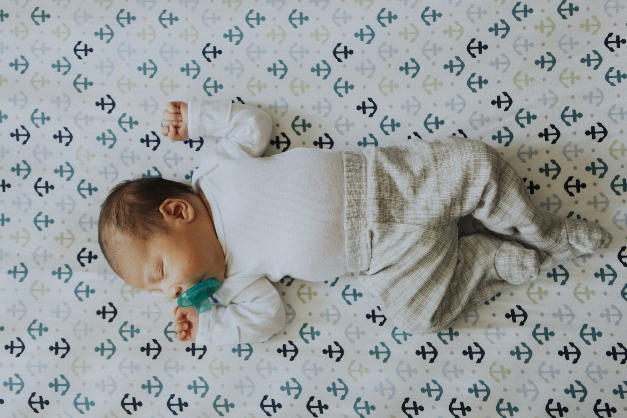 infant sleeping on her back in a crib