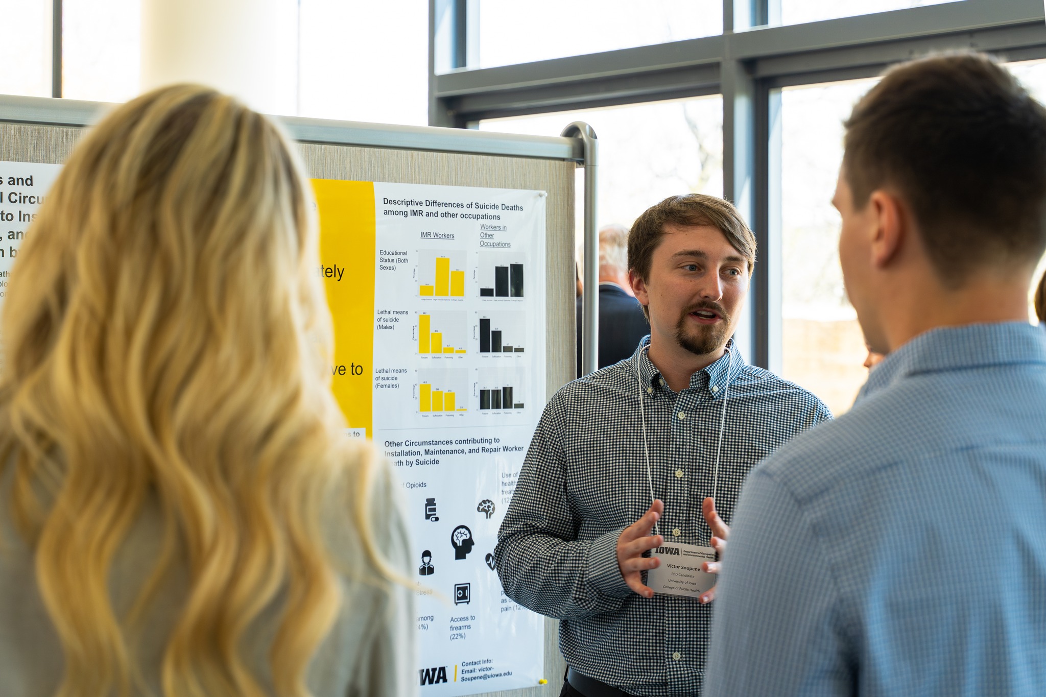 Victor Soupene presents his research during a poster session. 